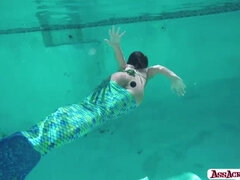 Gorgeous brunette babe Adriana Chechik cavorts in the pool wearing amermald costume and a giant fish tail. We go underwater, where she pushes huge bal