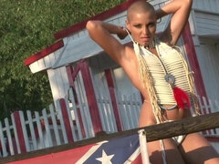 Stylish bald angel with nice long legs poses naked at the farm