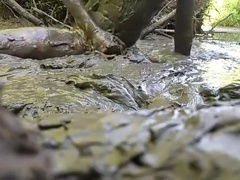 NUDE MAN PLAYING IN MUD HOLE