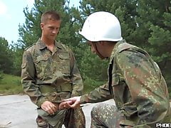 Young gays in uniform exchange blowjobs on the roadside