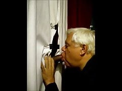 Old man sucking cock in a makeshift gloryhole