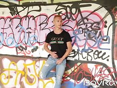 Young guy masturbates in public in front of graffiti wall