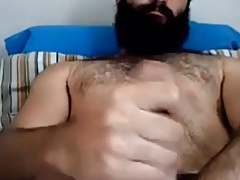 Handsome bearded guy stroking his big dick