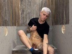 The stud masturbated off in the rest room and then he was joined by two penises in holes
