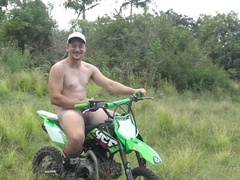 Sporty Aussie hunk riding a dirt bike with his bare booty exposed