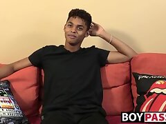 Black young man gives an interview and stimulates himself