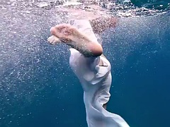 A girl from Tenerife swims naked underwater