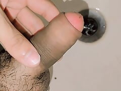 Young boy pissing in washroom