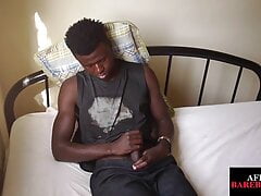 African jock solo stroking his uncut percker on bed