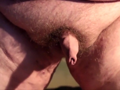 Fat boys tiny penis being pushed around while standing up.