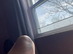 In front of window wearing thong