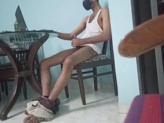 Young Indian guy milking himself at the dining table
