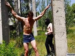 Sexy buff guy gets tortured in the forest