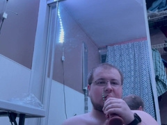 Plump stud experiences oral job on faux-cock