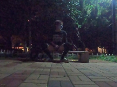 Fellow in black silk tempts passers-by on the side of the road for sucky-sucky bang-out