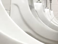 CIrcumcised male peeing at urinal