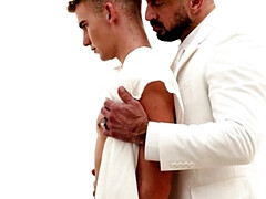 A man in a suit is banging the hell out of a petite lad