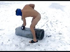 Naked boxer exercises on a frozen lake