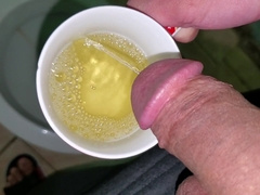 Guy Urinating in a Mug (close-up)