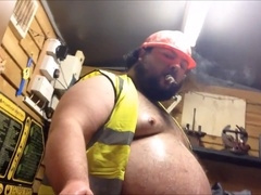 Oiled-up construction worker indulges in his grizzly fetish, smoking a cigar and embracing his chubby physique