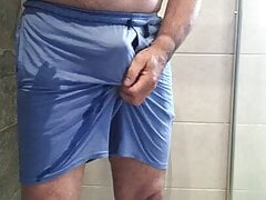 Pissing in blue shorts