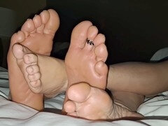 Massaging our feet while chilling in our motel room and watching TV