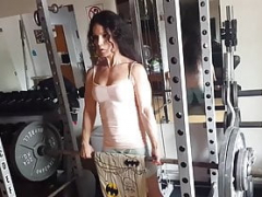 Sportive chick Tia lifting weight at the home gym