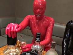 Couple in latex having sex in a bar