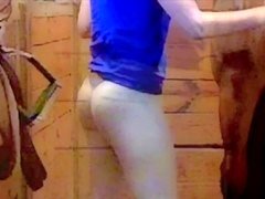 Coed wearing sheer tights grooms a horse