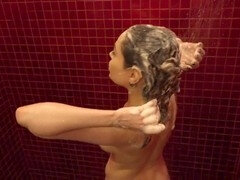 Woman enjoying a sudsy hair wash in the shower