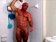 Soapy and oily shower with a muscular man