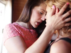 Two girls kiss one another and they are also slapping each others asses