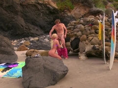 Blonde MILF in pink bra top enjoys young cock on the beach