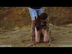 Submissive masochist Rocky Emerson tied atop a mountain and caned in the open air