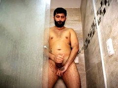 Super hot daddy Camilo Brown teases with his big uncut cock in the bathroom and unloads his jism