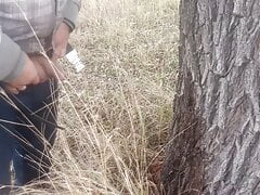 Pissed under a tree. Lots of piss from big cock