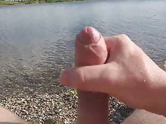Guy strokes cock on the beach