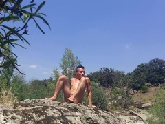 Gay male spread his legs and ass to take an anal vibrator in a public park