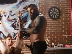 A tied lad is getting penetrated by a tattooed bear