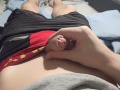 Guy in shorts jerks off his huge dick and cums while chilling at the computer