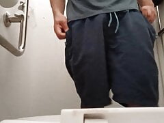 Pissing, fron view ina  public toilet