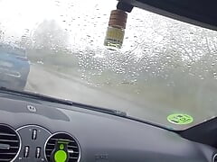 Horny in the car during a rainy day