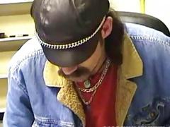 Slender bear with facial hair and lots of rings strokes his meat