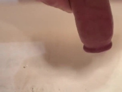 The man in the douche jacked off his gigantic hard-on and nutted