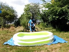 Cyclist pup in pool - cooling down and pawing off