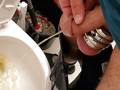 Penis at the toilet wearing balls weight, want to cum