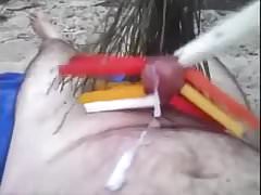 Weights on balls and clothes pegs on the cock