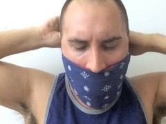 Muscular jock tied up and silenced with a tennis ball in mouth