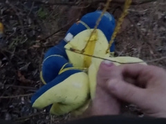 blue dinosaur Joy i urinating in woods