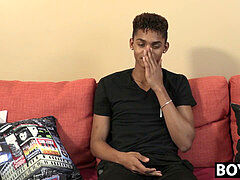 black youthfull guy gives an interview and stimulates himself
